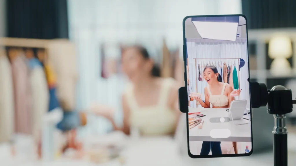 tiktok shop - Close-up de gravação da tela de telefone com mulher asiática mostrando paleta de maquiagem